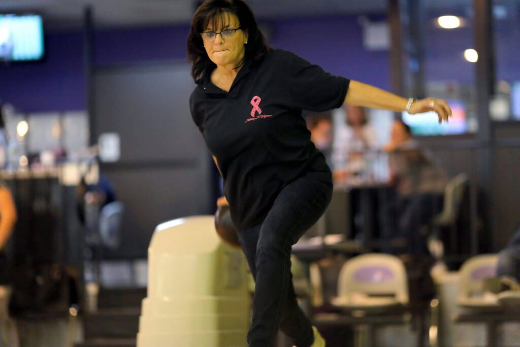 Woman throwing bowling ball