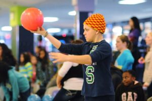 Teen boy about to throw bowling ball